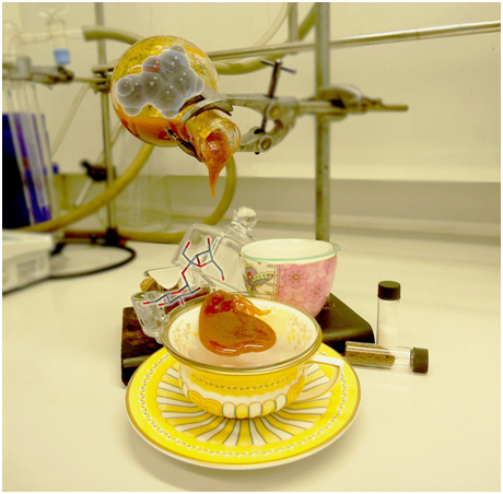 Round bottom flask containing sucrose and golden syrup mixture with HMF molecule. Sugar bowl with ball and stick sucrose model